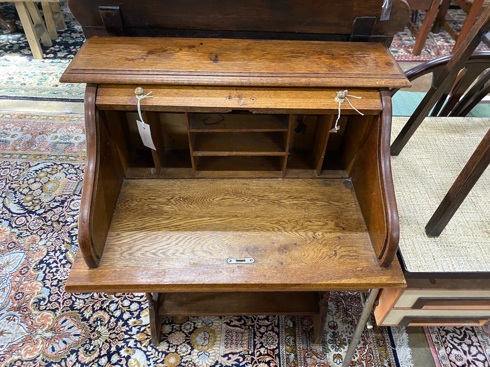 A 1920's oak roll top bureau with 'S' shaped tambour, width 69cm, depth 46cm, height 102cm